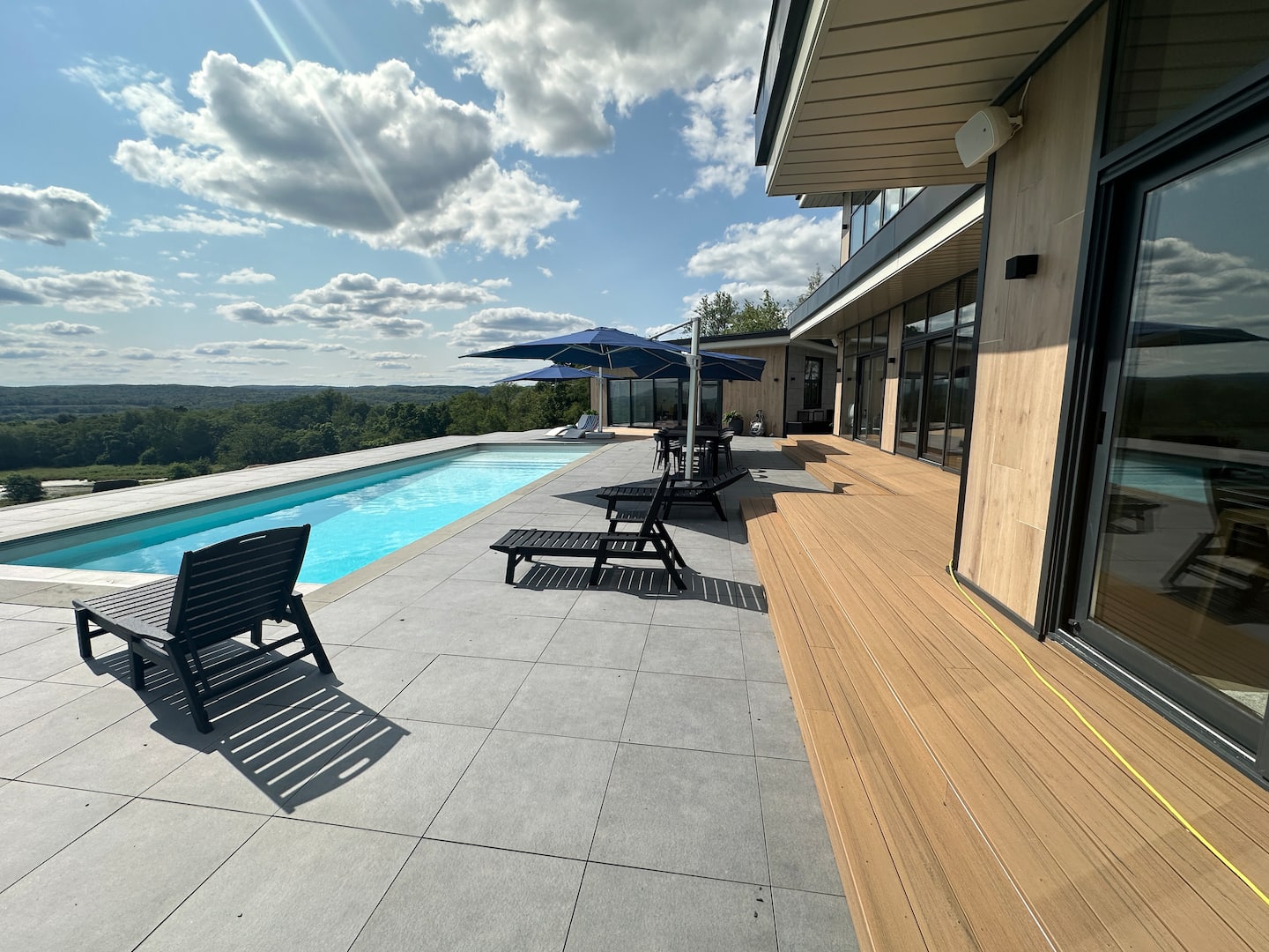 Pool terrace and wood deck overlooking the Hudson Valley